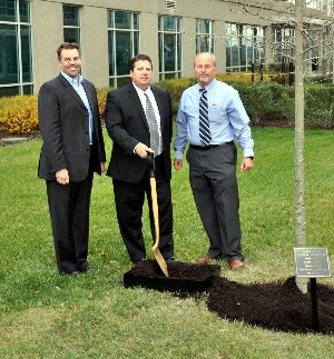 In December, Chuck Taylor (l), chapter president, Mark S. Zaroogian (c), director of information solutions, BAE Systems, and Michael Makfinsky, senior principal lead, CSC, plant a tree to honor the late Capt. Kirk N. Harness, USN (Ret.).